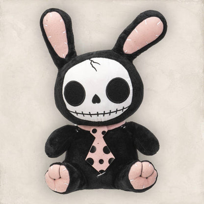 Black plush bunny with skull face, pink inner ears, paws, and spotted tie.