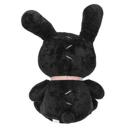Black plush bunny with long ears, pink collar, and small round tail sitting upright.