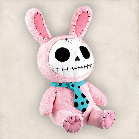 Pink bunny plush with skull face, black stitched eyes and mouth, wearing a blue polka dot tie.