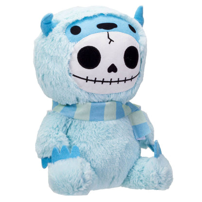 Light blue furry plush with a skull face, small horns, and a striped scarf.