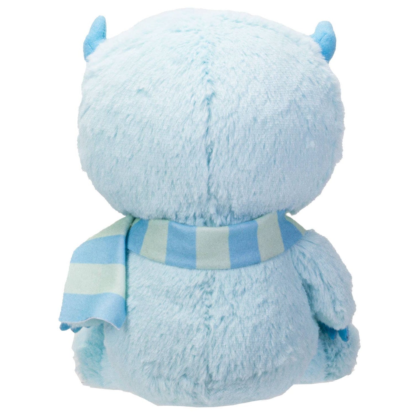 Light blue furry plush with small horns and a striped blue and green scarf, back view.