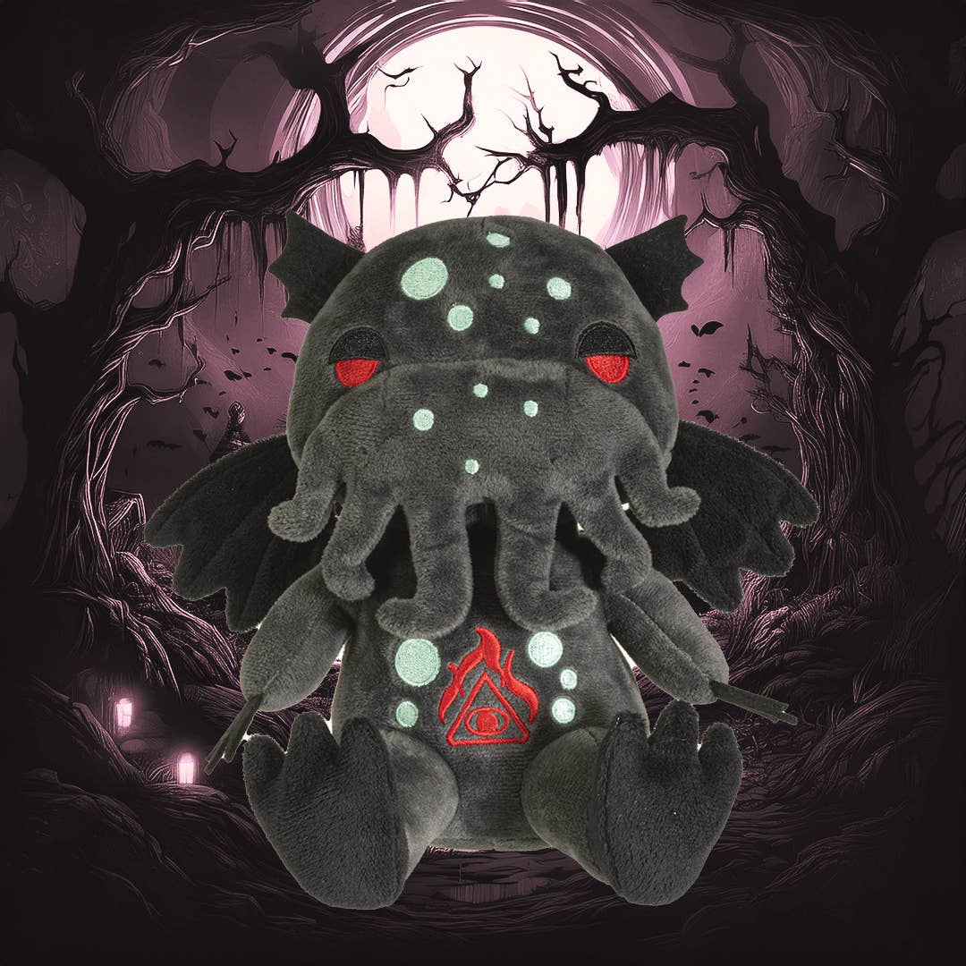 Dark gray Cthulhu plush with glowing blue spots, red eyes, wings, and tentacles on a mystical purple background.