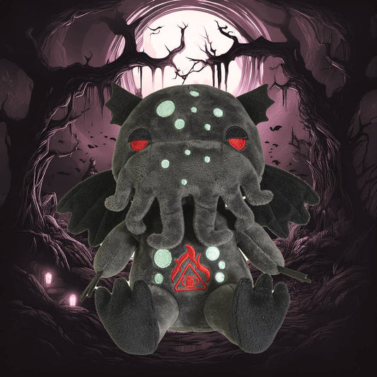 Dark gray Cthulhu plush with glowing blue spots, red eyes, wings, and tentacles on a mystical purple background.